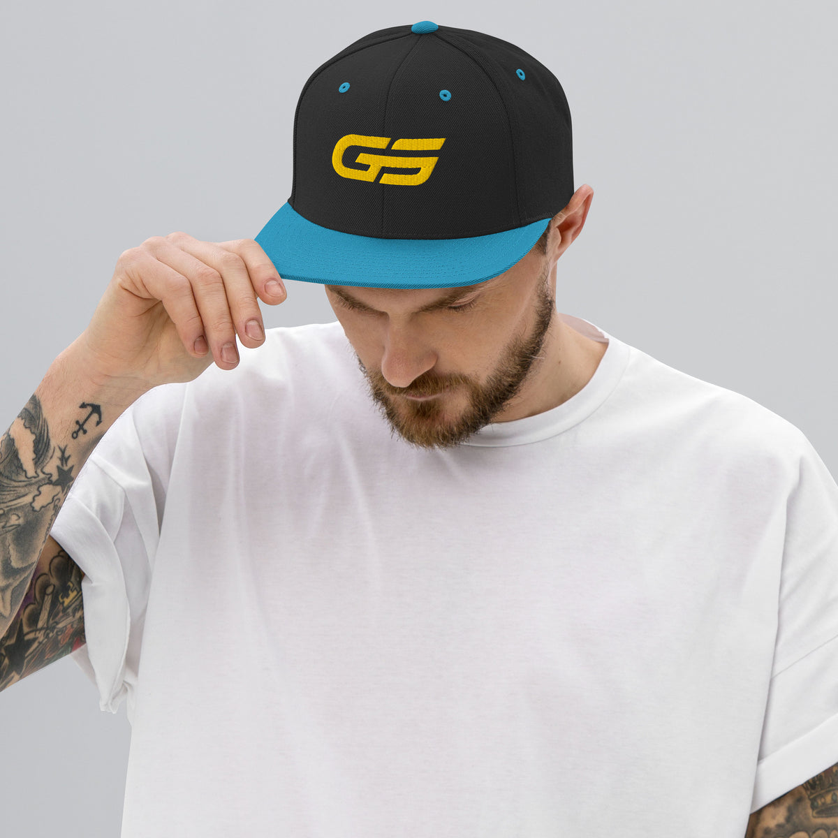 Casquette snapback noire/bleu turquoise avec logo GS jaune sur le devant